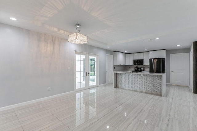 kitchen featuring appliances with stainless steel finishes, white cabinetry, french doors, hanging light fixtures, and kitchen peninsula