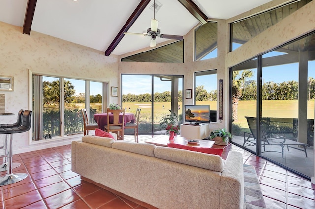 sunroom / solarium featuring ceiling fan and vaulted ceiling with beams