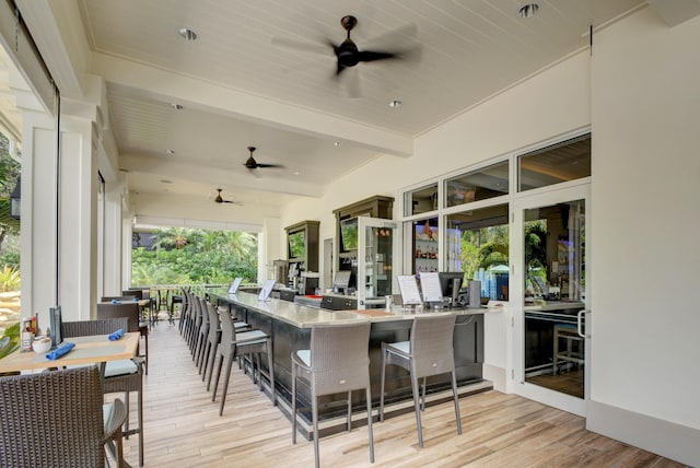 deck with ceiling fan and a bar