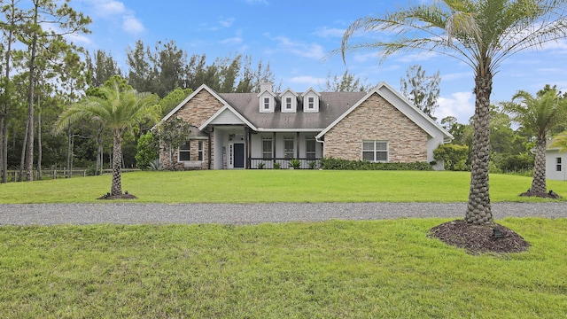 view of front of property with covered porch and a front yard