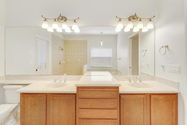 bathroom featuring toilet, vanity, and tiled shower