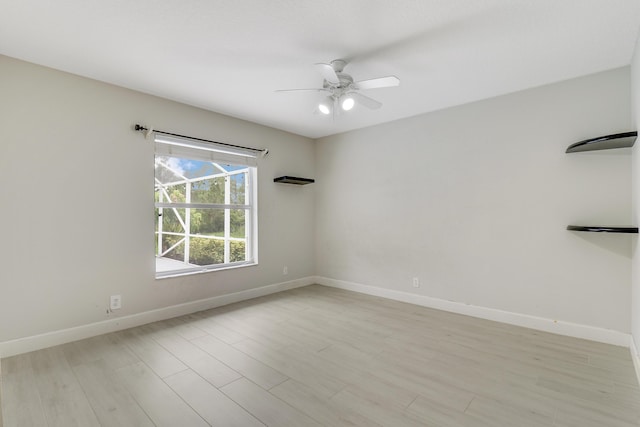 spare room featuring light wood-type flooring and ceiling fan