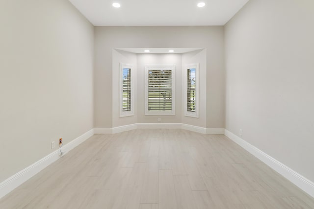 empty room with light hardwood / wood-style flooring