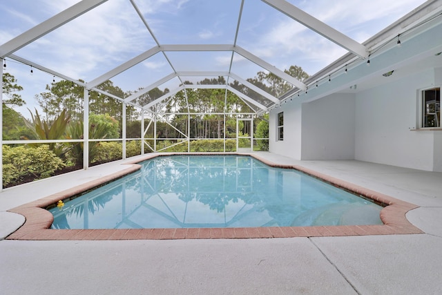 view of swimming pool with a lanai and a patio