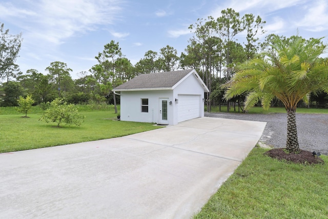 view of property exterior with a yard, an outdoor structure, and a garage