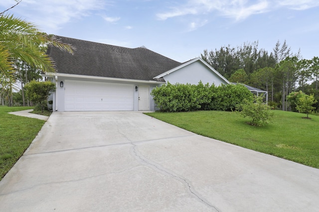 single story home featuring a garage and a front lawn