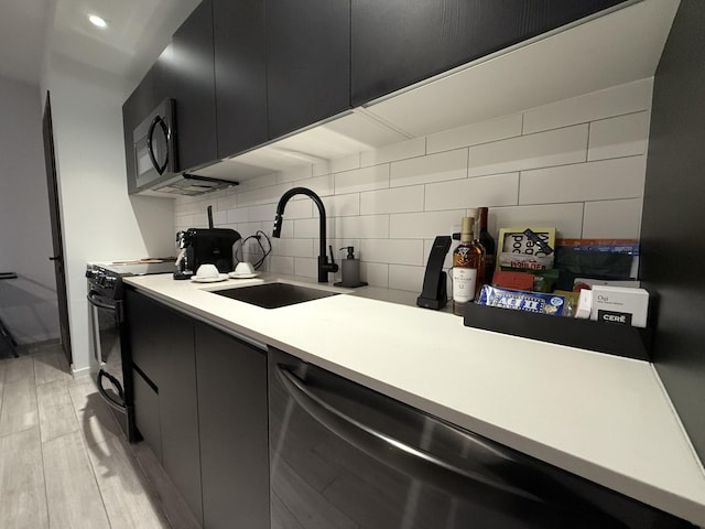 398 NE 5th St Unit 1715, Miami, FL 33132 - kitchen with tasteful backsplash, sink, dishwasher, light hardwood / wood-style floors, and black / electric stove