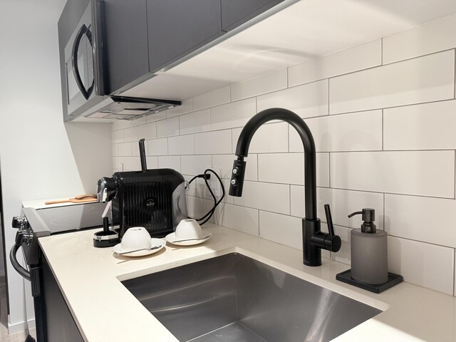 398 NE 5th St Unit 1715, Miami, FL 33132 - room details featuring decorative backsplash, sink, and electric range