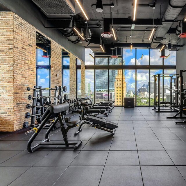 398 NE 5th St Unit 1715, Miami, FL 33132 - exercise room with floor to ceiling windows and a high ceiling