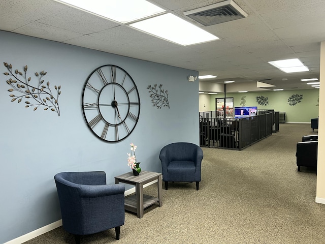 interior space featuring carpet and a drop ceiling