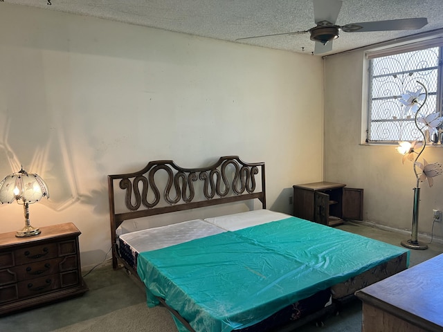 bedroom with ceiling fan and a textured ceiling