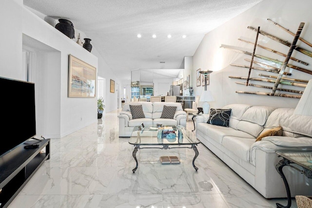 living room featuring a textured ceiling and vaulted ceiling