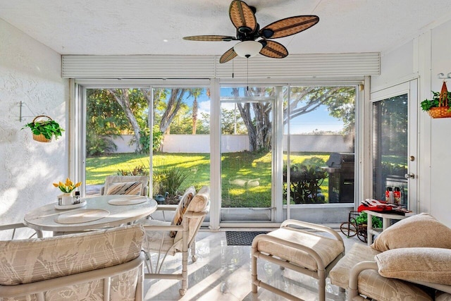 sunroom / solarium with ceiling fan and a healthy amount of sunlight