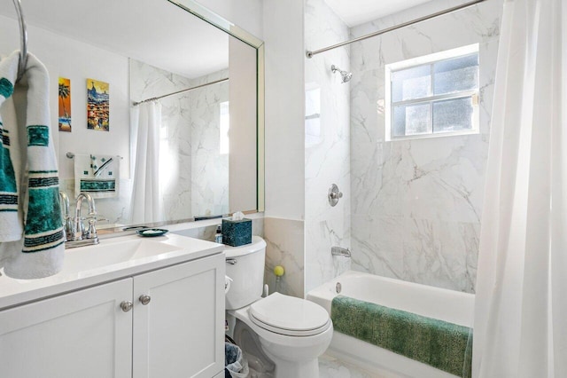 full bathroom with vanity, toilet, tile walls, and shower / tub combo with curtain