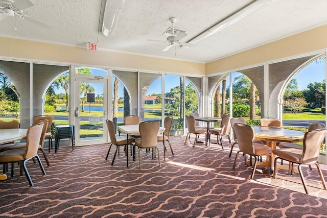 sunroom featuring ceiling fan