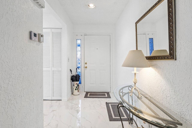 foyer featuring a textured ceiling