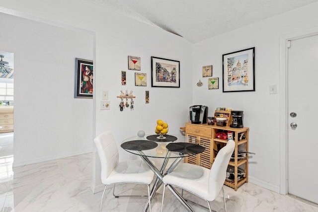 dining area with a textured ceiling