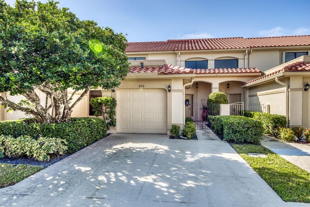 mediterranean / spanish-style home featuring a garage