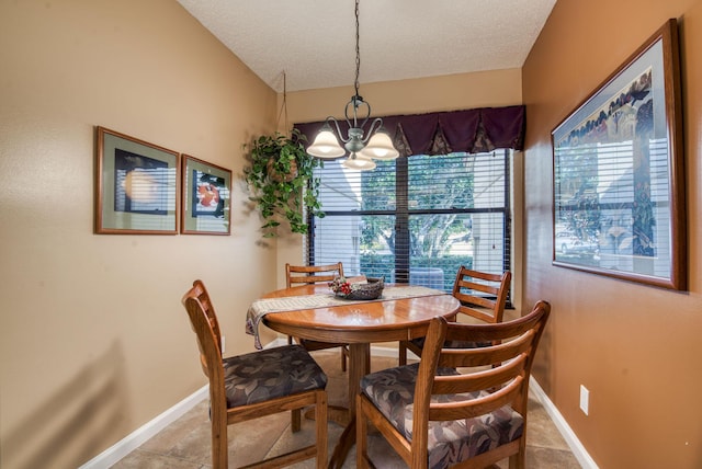 dining area featuring a chandelier, a textured ceiling, and vaulted ceiling