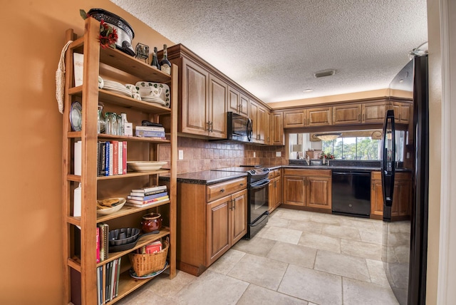 kitchen with black appliances, sink, dark stone countertops, a textured ceiling, and tasteful backsplash