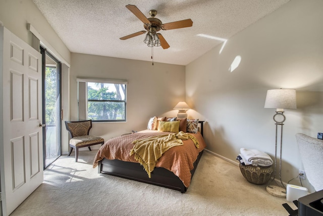 carpeted bedroom featuring a textured ceiling, access to outside, and ceiling fan