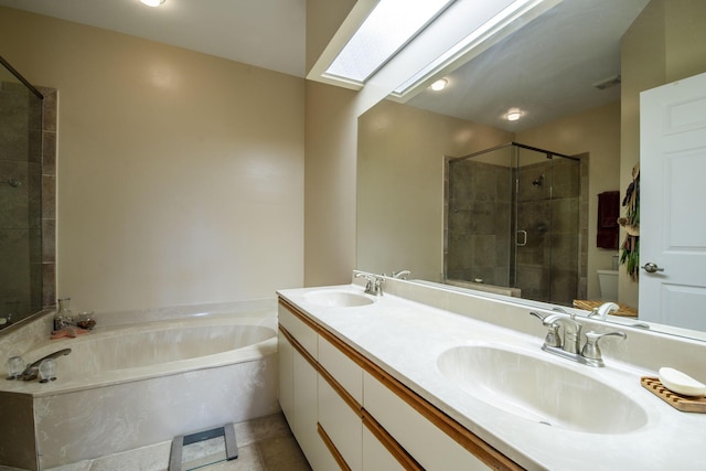 bathroom featuring vanity, a skylight, and independent shower and bath