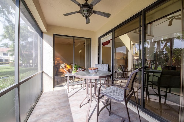 sunroom featuring ceiling fan