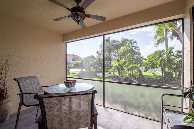 sunroom featuring ceiling fan