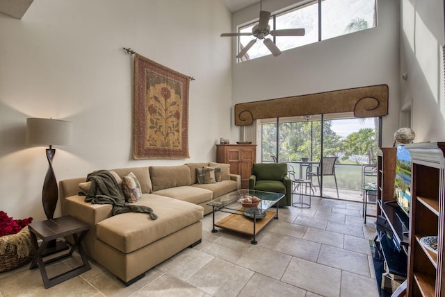 living room with a high ceiling and ceiling fan