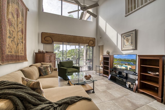 living room with a high ceiling and ceiling fan