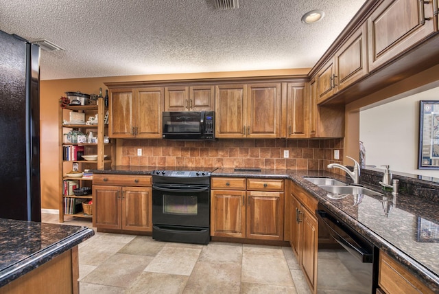 kitchen with sink, tasteful backsplash, dark stone countertops, and black appliances