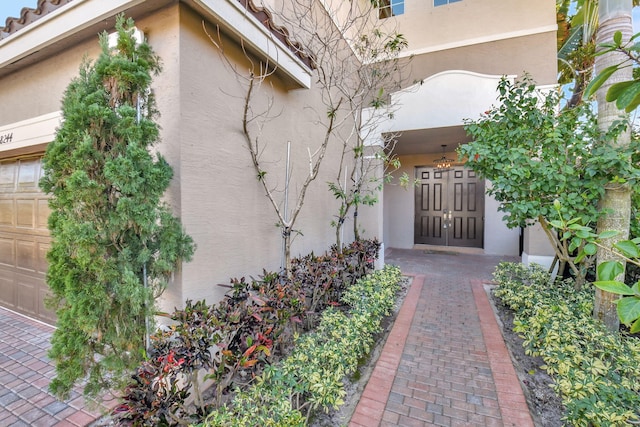 doorway to property with a garage