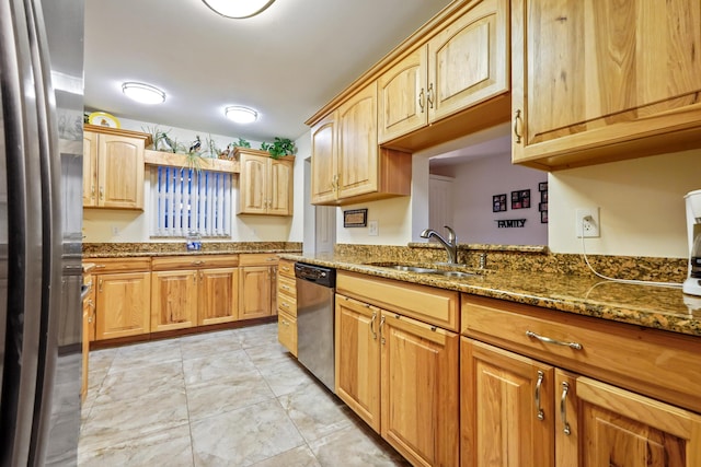 kitchen featuring a sink, stainless steel appliances, and stone counters