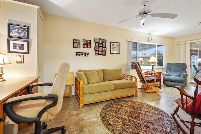 living room with ceiling fan and a textured ceiling