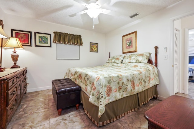 bedroom with visible vents, baseboards, a textured ceiling, and ceiling fan