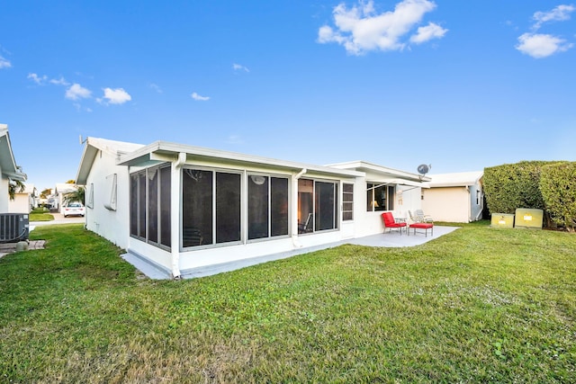 back of house with central air condition unit, a yard, a patio area, and a sunroom