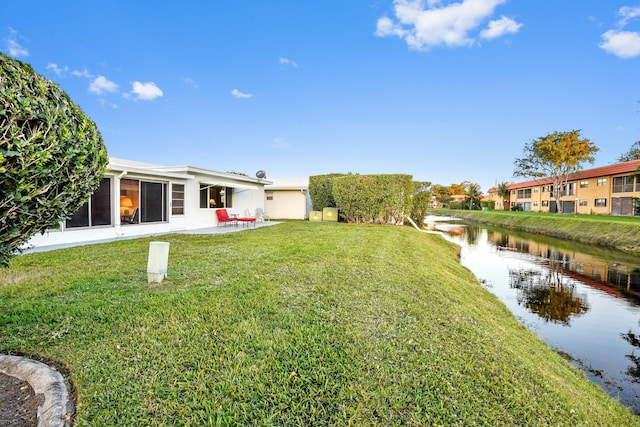 view of yard with a patio area and a water view