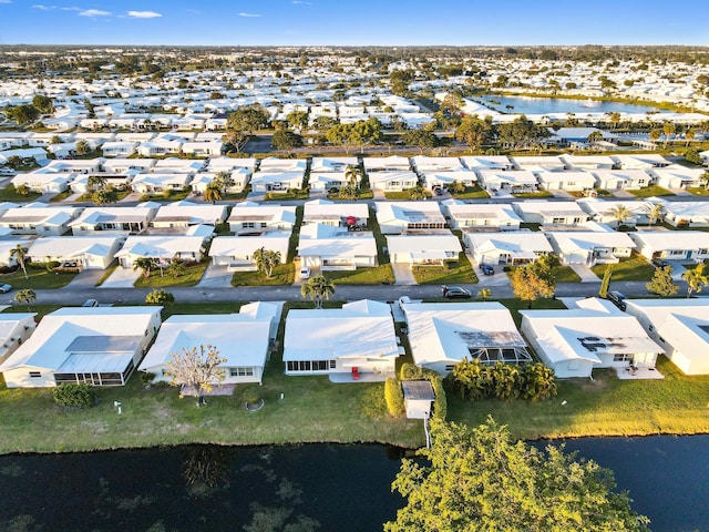 drone / aerial view featuring a residential view and a water view