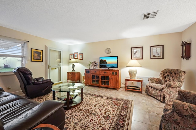 living area with visible vents and a textured ceiling