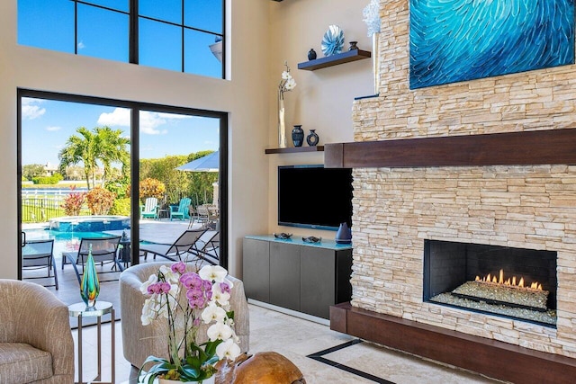 living room featuring a stone fireplace