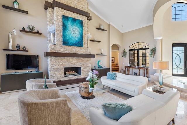 living room with ornamental molding, a fireplace, and high vaulted ceiling