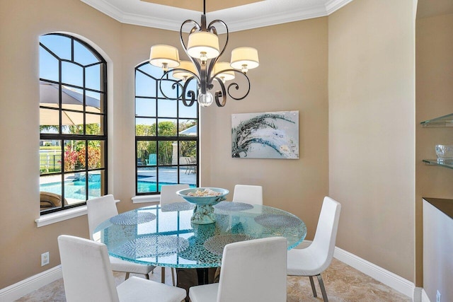 dining area featuring plenty of natural light, ornamental molding, and a chandelier