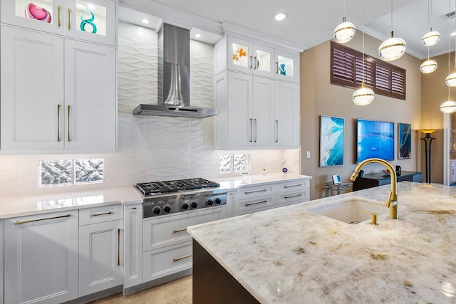 kitchen featuring white cabinetry, stainless steel gas cooktop, wall chimney exhaust hood, and sink