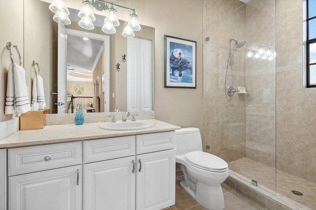 bathroom with tile patterned floors, vanity, toilet, and a tile shower