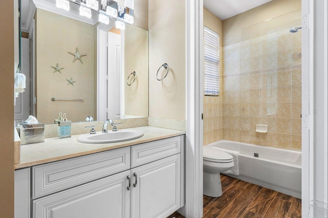 full bathroom with vanity, toilet, and tiled shower / bath combo