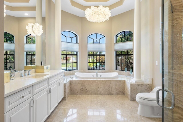 bathroom with vanity, a relaxing tiled tub, a chandelier, a high ceiling, and toilet