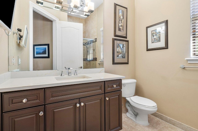 bathroom with tile patterned flooring, vanity, and toilet