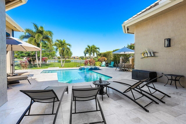 view of pool featuring an in ground hot tub and a patio