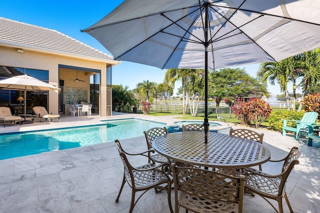 view of swimming pool with a patio area and ceiling fan