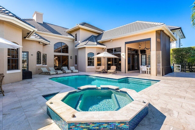 view of swimming pool with an in ground hot tub and a patio